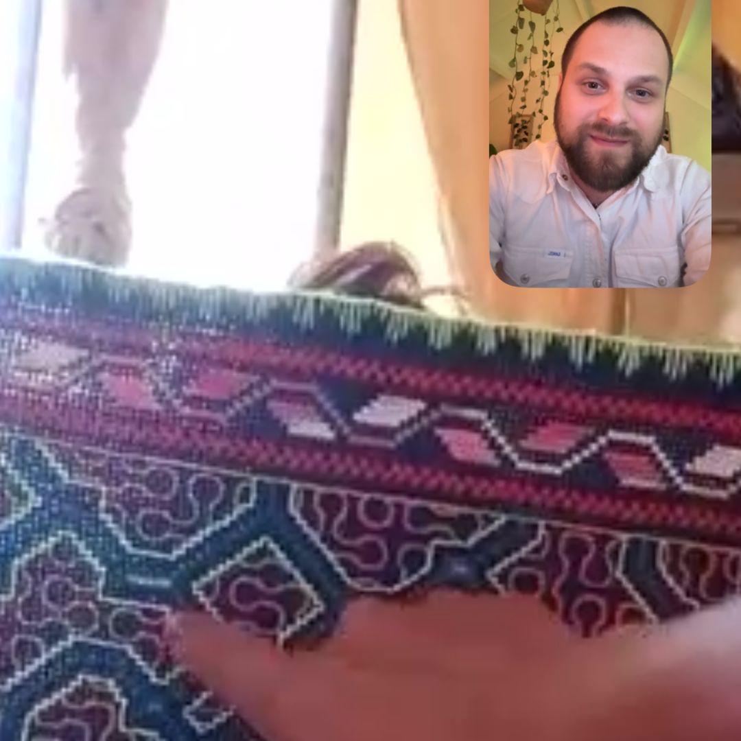 A hand-woven Kené textile shown during a conversation