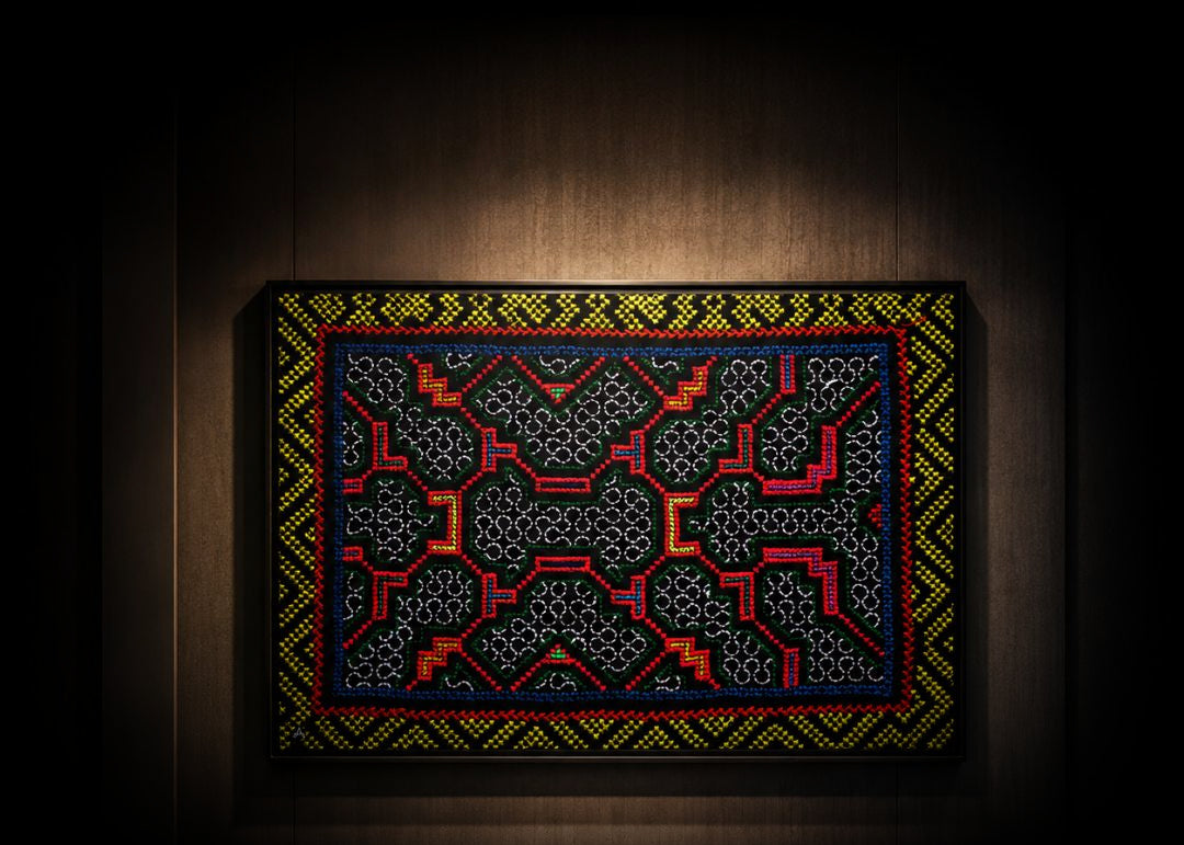 NII SHINAN Kené canvas on a dark wooden wall